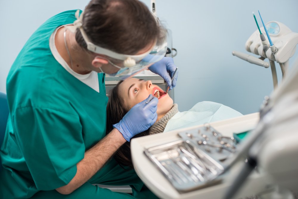 Male,Dentist,With,Dental,Tools, ,Mirror,And,Probe,Checking